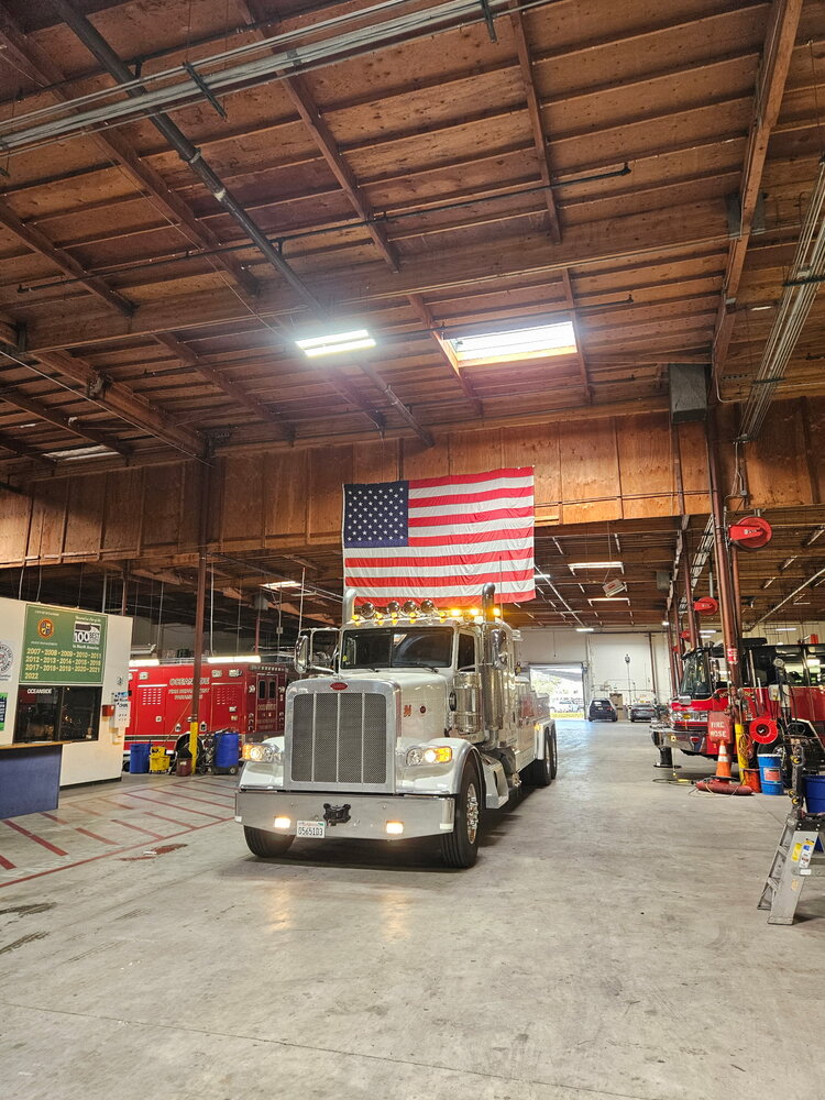 NK Towing heavy-duty wrecker parked inside the Oceanside Fire Department station